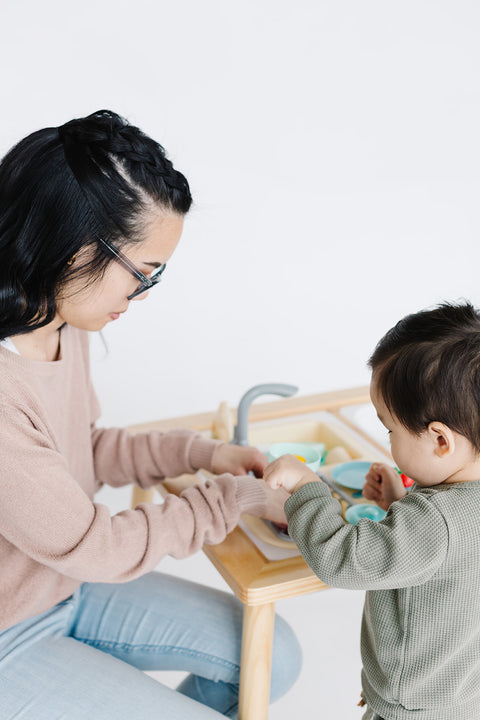 An adult and a child find joy in kitchen pretend play with the Play Kitchen Sink Toys with Large Bin, exploring imaginative cooking adventures together.
