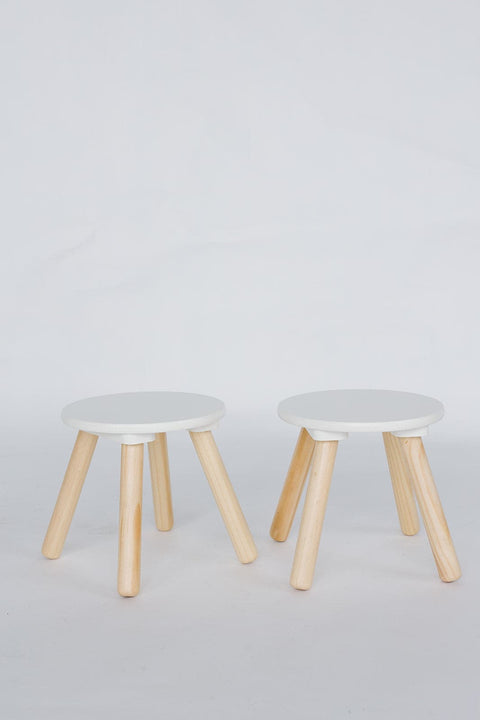 Two small round stools from the "Round Wooden Stools, 1 Pack," featuring solid wood legs and white tops, are placed side by side against a plain background.